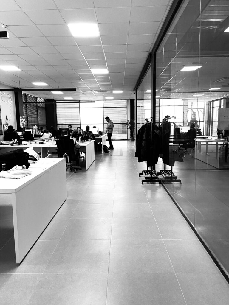 pexels-photo-3415148-3415148 Black and white of anonymous employees working together in modern office with glass walls